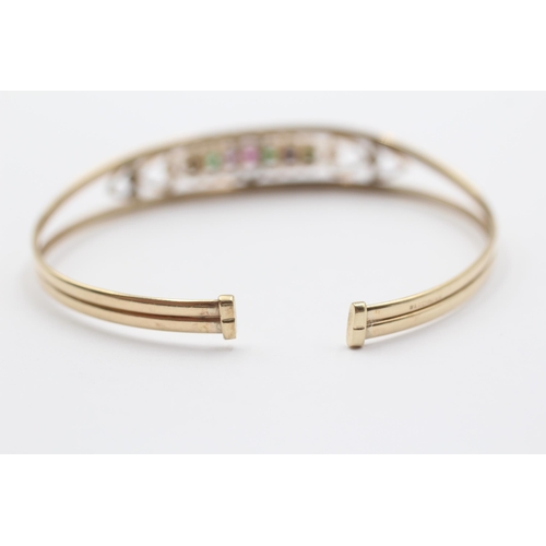 2034 - A 9ct gold diamond, emerald, amethyst, ruby, sapphire and tanzanite 'Dearest' acrostic bangle - appr... 