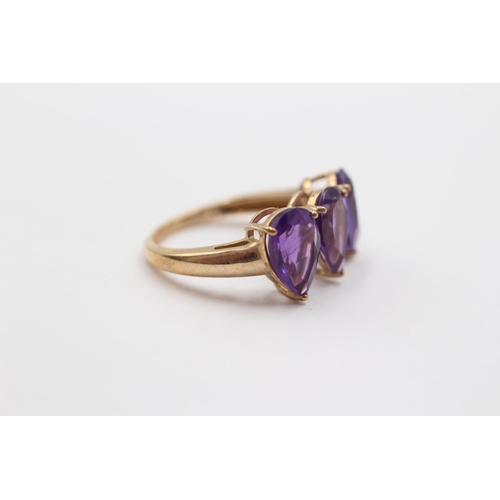 2048 - A 10ct gold amethyst teardrop trilogy ring - approx. gross weight 2.6g