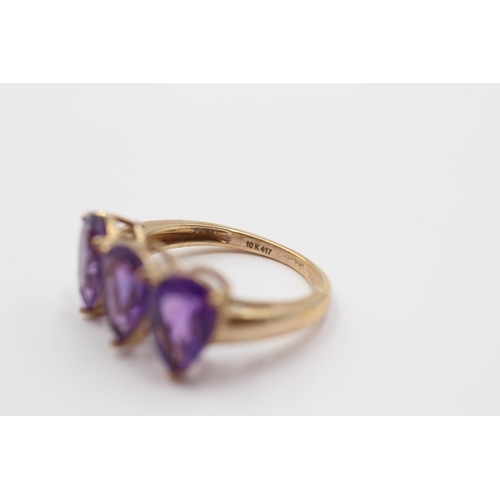 2048 - A 10ct gold amethyst teardrop trilogy ring - approx. gross weight 2.6g