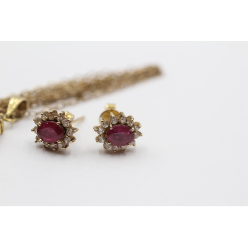 2051 - A 9ct gold ruby and clear gemstone halo pendant necklace and earrings set - approx. gross weight 4.3... 