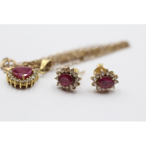 2051 - A 9ct gold ruby and clear gemstone halo pendant necklace and earrings set - approx. gross weight 4.3... 