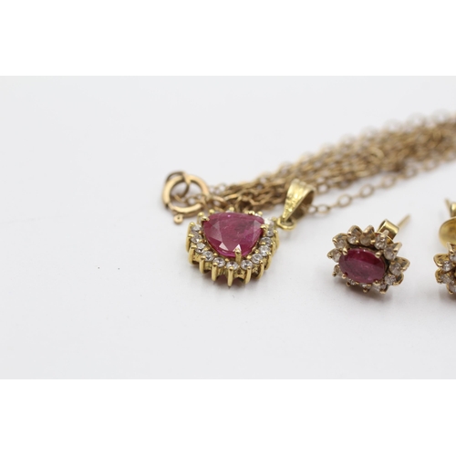 2051 - A 9ct gold ruby and clear gemstone halo pendant necklace and earrings set - approx. gross weight 4.3... 