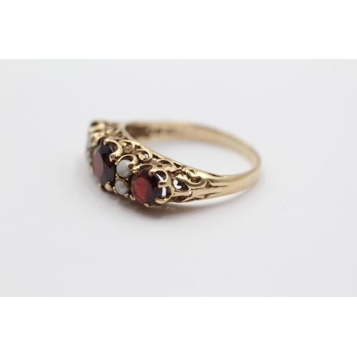 2054 - A 9ct gold garnet and seed pearl seven stone ring - approx. gross weight 3.1g