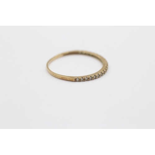 2058 - A 9ct gold clear gemstone half-eternity ring - approx. gross weight 0.6g