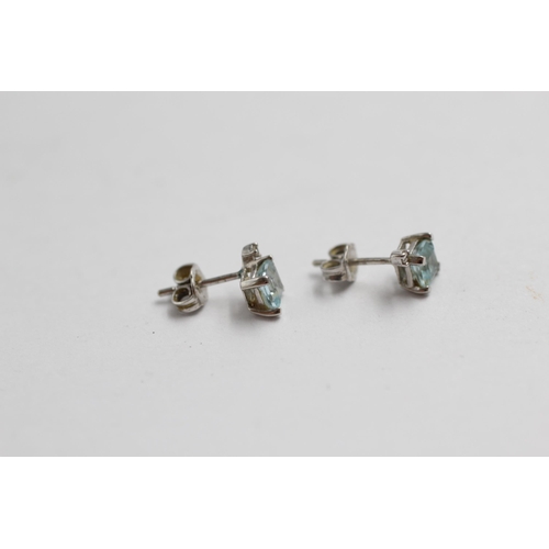 2065 - A pair of 9ct white gold topaz and diamond stud earrings - approx. gross weight 0.8g