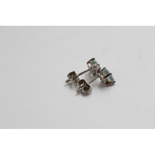 2065 - A pair of 9ct white gold topaz and diamond stud earrings - approx. gross weight 0.8g