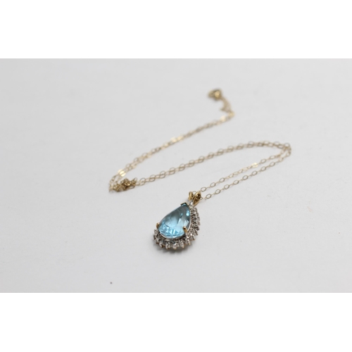 2133 - A 9ct gold blue topaz and diamond teardrop halo pendant necklace - approx. gross weight 3g