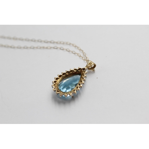 2133 - A 9ct gold blue topaz and diamond teardrop halo pendant necklace - approx. gross weight 3g