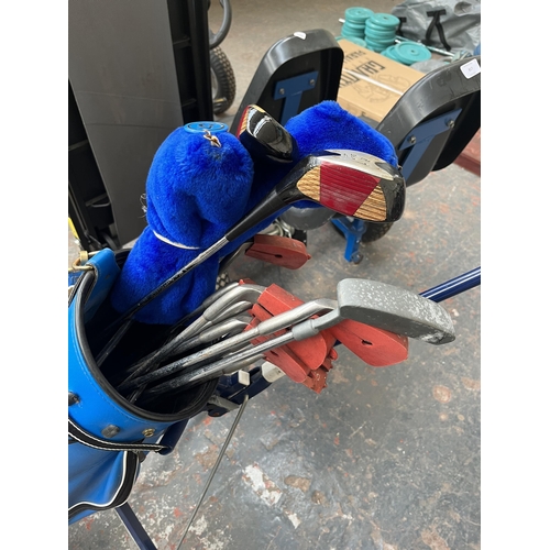 703 - A golf trolley and bag containing clubs to include Wilson 4300, Green Killer IV etc.