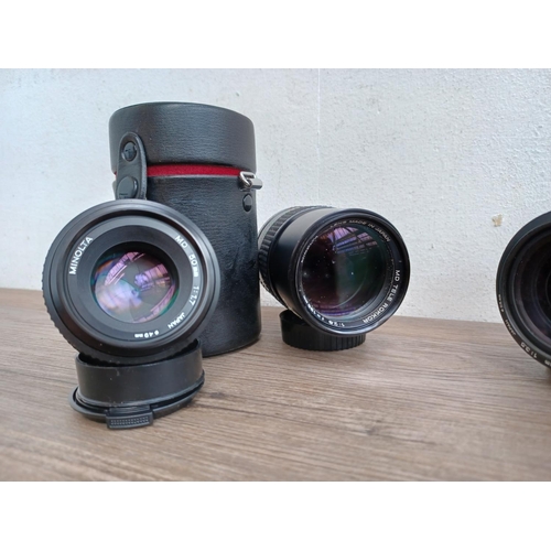 486 - Four Minolta MD camera lenses, one cased Rokkor tele 1:2.8 f=135mm, one 1:1.7 50mm, one zoom 1:3.5 3... 