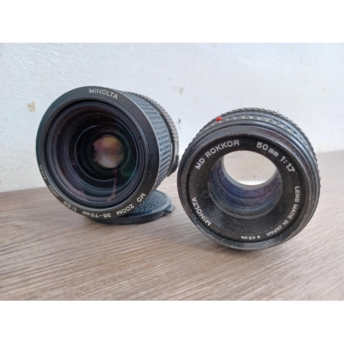 486 - Four Minolta MD camera lenses, one cased Rokkor tele 1:2.8 f=135mm, one 1:1.7 50mm, one zoom 1:3.5 3... 