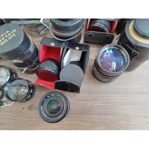 502 - A collection of boxed and cased camera lenses and tele-converters to include Yashica, Hanimex, Minol... 