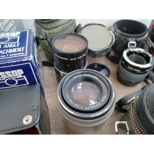 502 - A collection of boxed and cased camera lenses and tele-converters to include Yashica, Hanimex, Minol... 