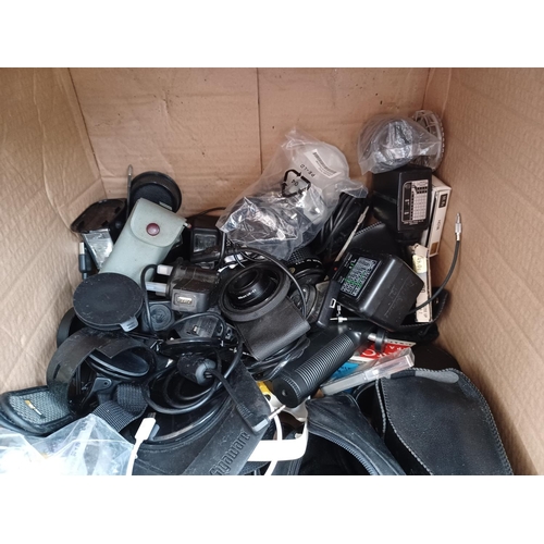 510 - Two boxes containing a large quantity of camera equipment and accessories to include cases, flashes,... 