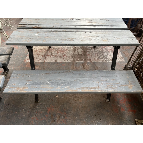 731 - A cast iron and grey painted wooden slatted outdoor bench - approx. 74cm high x 143.5cm long x 157cm... 