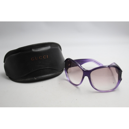 2383 - A pair of Gucci purple framed sunglasses with original case