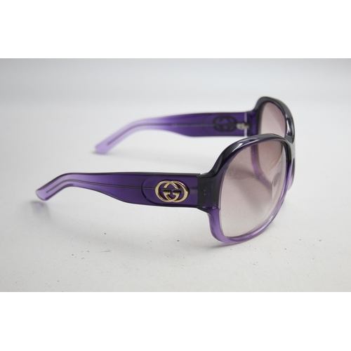 2383 - A pair of Gucci purple framed sunglasses with original case