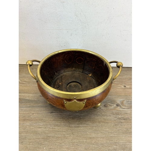 463 - An early 20th century oak and EPNS tri-footed twin handled circular bowl - approx. 23cm diameter