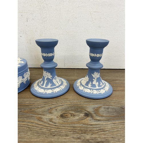 269 - Six pieces of Wedgwood pale blue Jasperware to include two candlesticks - approx. 12.5cm high etc.