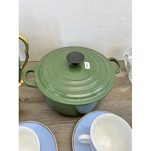 303 - A collection of items to include Le Creuset green enamel and cast iron no. 20 twin handled casserole... 