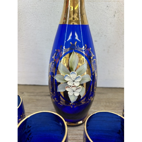 308 - A Murano cobalt blue glass seven piece drinking set with gilt and floral decoration