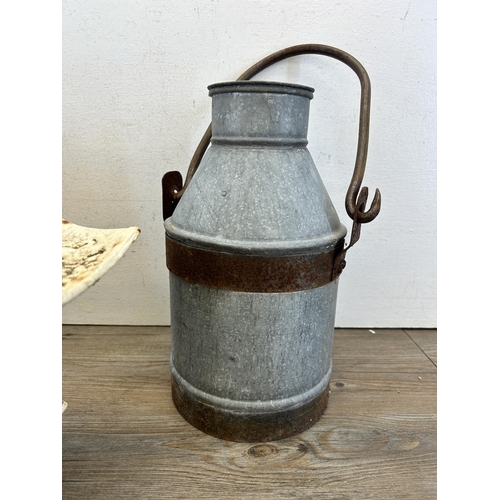 318 - Three pieces of metalware, two galvanised milk churns and one cast iron pagoda lantern - milk churns... 