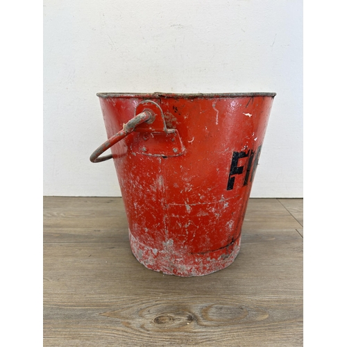 336 - A mid 20th century red painted metal fire bucket - approx. 30cm high x 32cm diameter