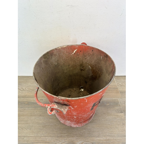 336 - A mid 20th century red painted metal fire bucket - approx. 30cm high x 32cm diameter