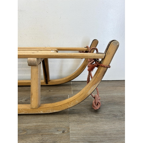 344 - A vintage Criterion Davos Stock No. 05-35 beech snow sledge with metal runners - approx 25cm high x ... 