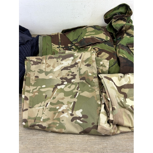 386 - Five pieces of military clothing to include British Army Woodland pattern combat jacket and Para smo... 