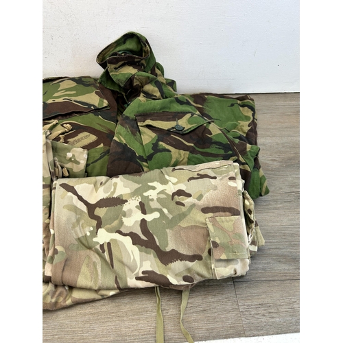 386 - Five pieces of military clothing to include British Army Woodland pattern combat jacket and Para smo... 