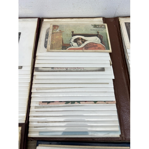 396 - Four albums containing a large collection of antique and vintage postcards to include silk, birthday... 