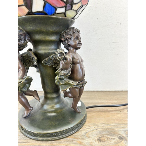 408 - A Widdop Bingham & Co Ltd bronze effect resin figural table lamp with Tiffany style stained glass sh... 