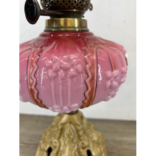 410 - A late 19th/early 20th century A. L. C. gilt metal and pink glass oil lamp with clear glass funnel -... 