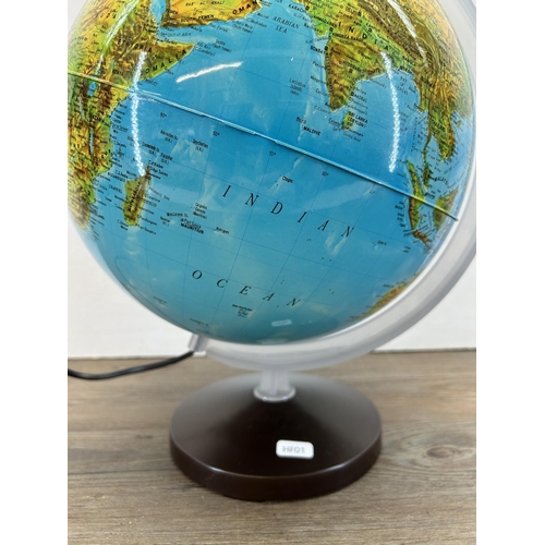 426 - An illuminating terrestrial globe - approx. 40cm high