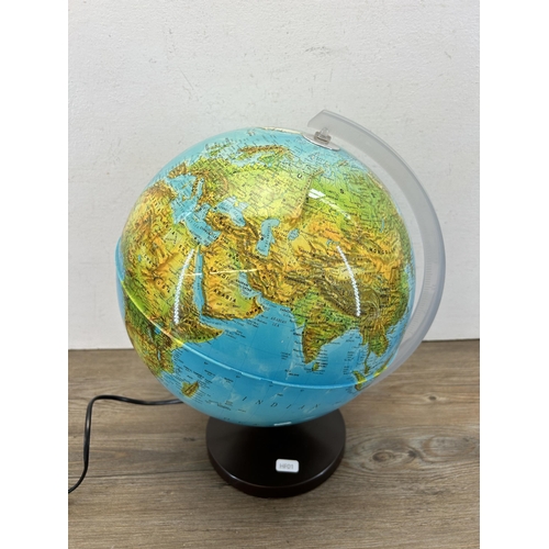 426 - An illuminating terrestrial globe - approx. 40cm high