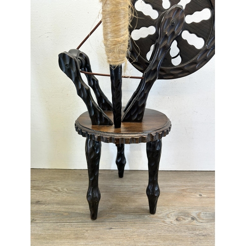 453 - A Spanish carved hardwood spinning wheel - approx. 72cm high