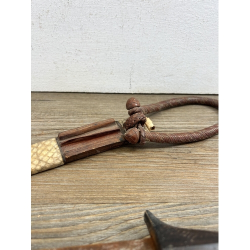 458 - A vintage ethnographical dagger with carved hardwood handle and leather sheath - approx. 39cm long