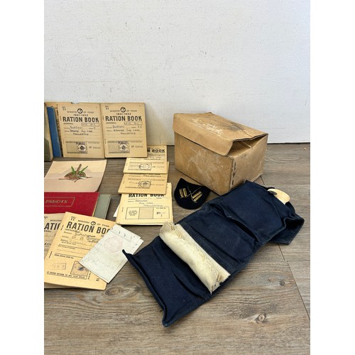 404 - A collection of militaria to include two gas masks, Ministry of Food ration books etc.