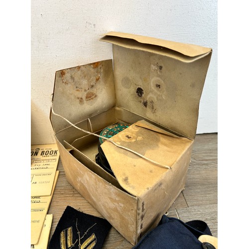 404 - A collection of militaria to include two gas masks, Ministry of Food ration books etc.