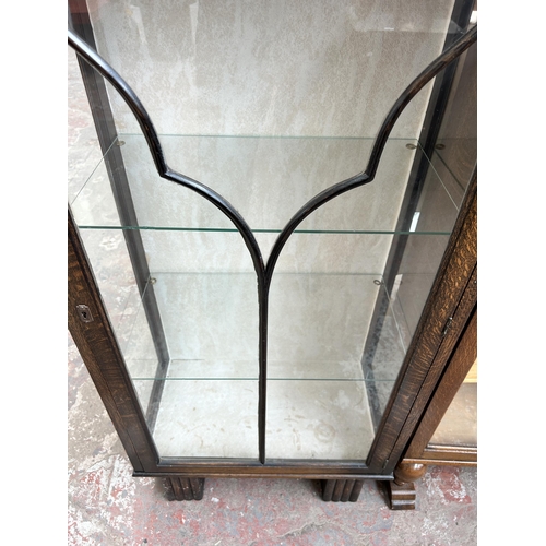 107 - An Art Deco oak bookcase with single glazed door and two internal glass shelves