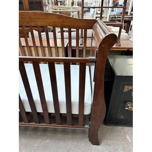 109 - A mahogany sleigh cot bed with mattress - approx. 84cm high x 76cm wide x 160cm long