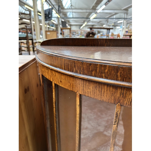 118 - A mid 20th century oak and walnut bow fronted display cabinet with two glazed doors and two internal... 