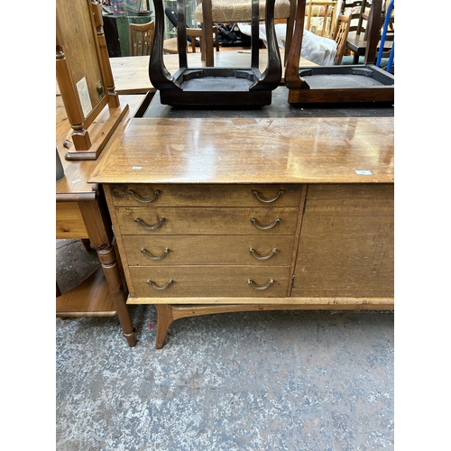 124 - A mid 20th century Alfred Cox walnut sideboard with four drawers and two cupboard doors - approx. 80... 