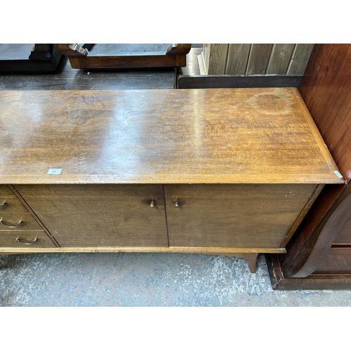 124 - A mid 20th century Alfred Cox walnut sideboard with four drawers and two cupboard doors - approx. 80... 