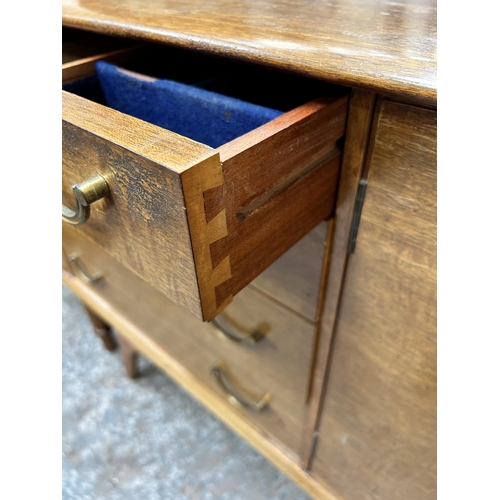 124 - A mid 20th century Alfred Cox walnut sideboard with four drawers and two cupboard doors - approx. 80... 