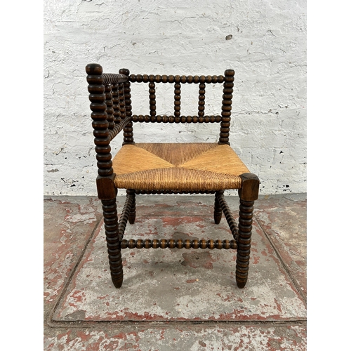 13 - A 19th century style bobbin turned and rush seated corner chair - approx. 65cm high x 62cm wide x 62... 