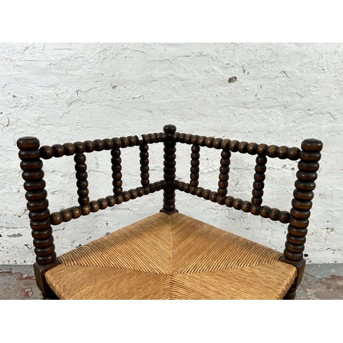 13 - A 19th century style bobbin turned and rush seated corner chair - approx. 65cm high x 62cm wide x 62... 