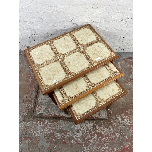 132 - A mid 20th century Danish style teak and tiled top nest of three tables