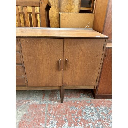 139 - A mid 20th century Stag teak sideboard with three cupboard doors and four central drawers - approx. ... 